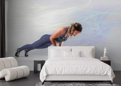 Beautiful Caucasian fitness model wearing long fitness outfit and flower patterned sports bra doing a pushup on a ball  Wall mural