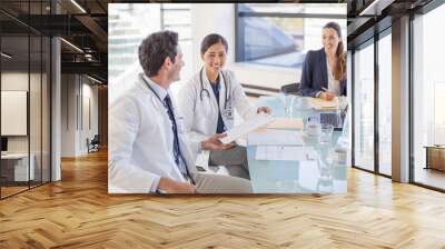 Doctors and businesswoman talking in meeting Wall mural