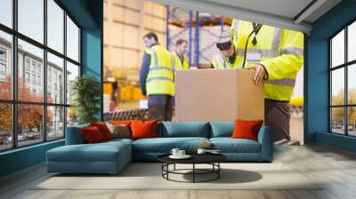 Worker scanning box on conveyor belt in warehouse Wall mural