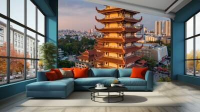 Buddhist Temple with prayer tower in urban setting with beautiful golden afternoon light. City skyline and rooftops can be seen in the background Wall mural