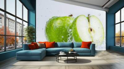 Close-up of a green apple split in half, exposing the core and seeds, with droplets of water on the surface, set against a clean white background Wall mural