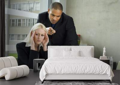 business man giving a female work college a hard time Wall mural