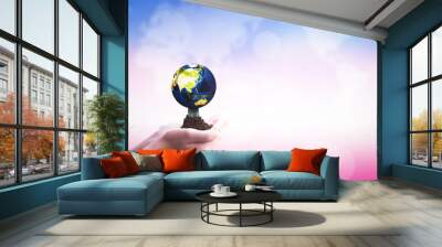 International Day of Cooperatives concept: hands holding Earth  on blurred  nature background Wall mural