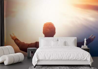 International Day of Peace concept: Silhouette of man raised hands at  sunset background Wall mural