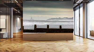 A stormy, cloudy and blustery day at Blyth beach in Northumberland, as the waves batter the coast Wall mural