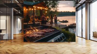 Lakeside barbecue party at a rustic cabin, grill loaded with meats, guests in casual attire chatting by the water, warm evening glow, relaxed atmosphere Wall mural