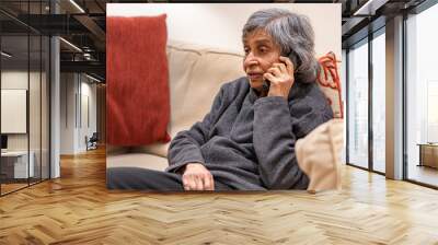 Old elderly woman talking on a phone while self isolating Wall mural