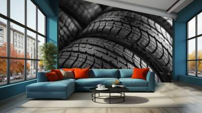 Pile of four brand new black wheel tires for a car, emphasizing the pristine rubber and intricate tread patterns Wall mural