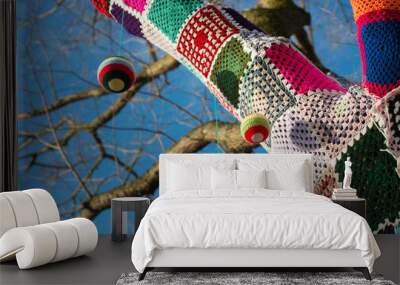 knitted woollen yarn bomb tree with baubles and blue sky background Wall mural