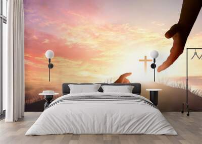 Silhouette of  God's giving a helping hand, hope and support each other over sunset background. Wall mural