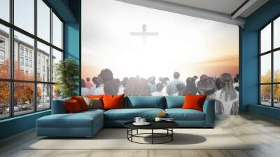 soft focus of christian people group raise hands up worship God Jesus Christ together in church revival meeting with image of wooden cross over cloudy sky can be used for Christian worship background Wall mural