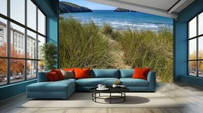 Two rocky islands off Holywell Bay in Cornwall, England, UK with grassy sand dunes in the foreground. Wall mural