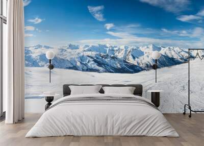 Panoramic view down snow covered valley in alpine mountain range Wall mural