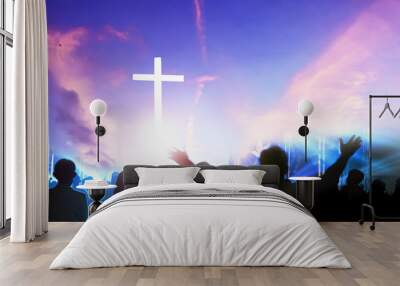 Worship and praise concept: Silhouette many people raised hands over sunset background Wall mural