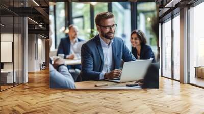 Business team meeting with focus on a smiling man using laptop Wall mural