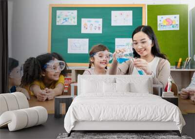 Diversity children doing a chemical experiment in laboratory at school. Portrait of happy kids at elementary school learning science chemistry with asian teacher. Fun study back to school concept. Wall mural