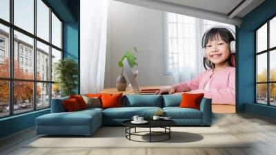 Portrait of Asian girl using computer to learn online live lessons in elementary school. Student boy studying in primary Children with gadgets at home. Education knowledge, technology internet network Wall mural