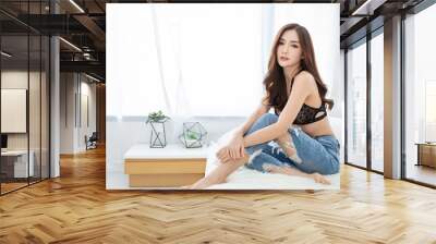 Portrait of asian sexy woman with a delicate fair skin in black lace underwear bra sexually sit in white bed room. Asian sexy girl wakeup in morning, modern lifestyle, skin care concept Wall mural