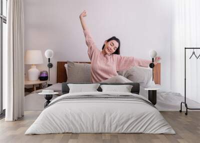 Portrait of beauty happy asian sexy woman awaking, wake up on the bed (sleep). Young beautiful asian girl stretching her arms in fresh early morning, relax peaceful morning routine concept banner Wall mural