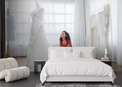 Portrait of bride preparing for the wedding. African american woman dealer consultant designer in the background of wedding dresses studio. Happiness success dream come true concept Wall mural