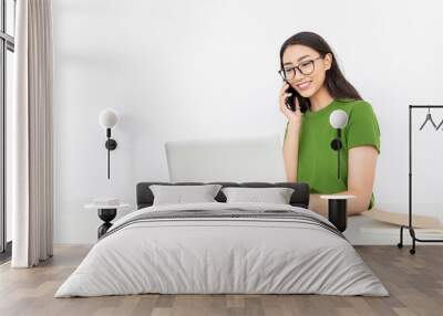 Portrait of young asian business woman talk on smartphone write notebook laptop in home office. Beautiful girl at desk computer take order. Startup business asia woman online telemarketing sme owner Wall mural