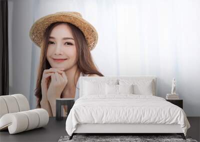 Portrait of young beautiful asian woman on holiday vacation summer time in white bedroom. Happy cheerful relaxing girl in summer. Korean makeup skincare university, woman fashion lifestyle concept. Wall mural