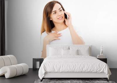 Beautiful woman in white t shirt using a mobile phone isolated on a white background. Wall mural