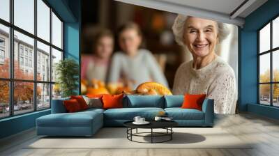 smiling old woman holding juicy roasted turkey for thanksgiving on background of family and table with food, generative AI Wall mural