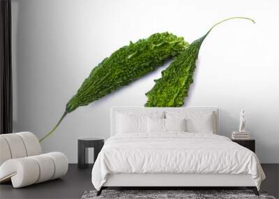 two green bitter gourd vegetables lie on a white background Wall mural