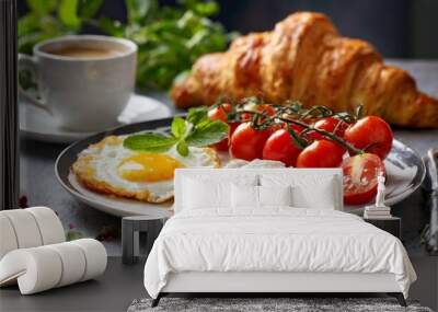 a breakfast plate with two eggs tomatoes croissants Wall mural