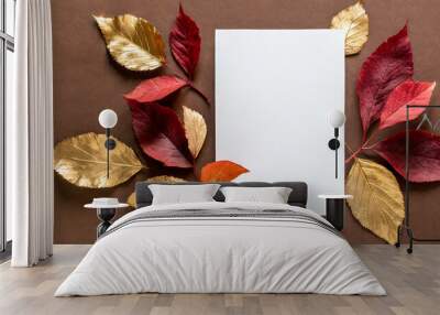 autumn composition with white paper blank and dried red and golden leaves on brown background autumn fall invitation concept thanksgiving mockup greeting card flat lay top view with copy space Wall mural