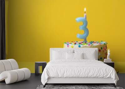 Sweet 3rd Birthday: Colorful Cake with Candle on Vibrant Yellow Background Wall mural