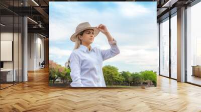 Agribusiness woman wearing hat and jeans at the end of a working day.. Wall mural