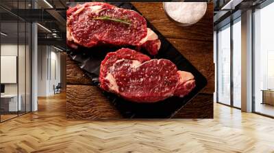 Raw ancho meat  for cooking on dark cutting board. Wooden background. Wall mural