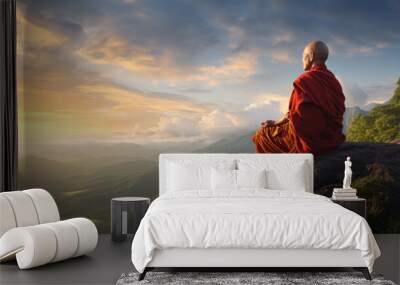 Buddhist monk in meditation at beautiful sunset or sunrise background on high mountain Wall mural