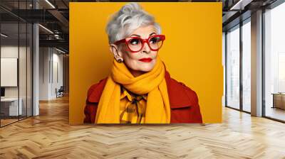 Happy elegant mature senior business woman laughing standing isolated on yellow background. Smiling confident hipster 60s lady with dental white smile looking at camera. Wall mural