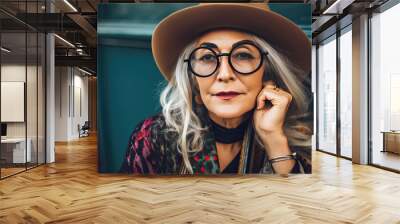 Hipster senior woman wearing glasses and fashionable hat outdoors portrait Wall mural