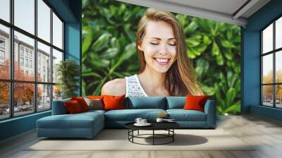 Beautiful smiling girl with eyes closed Wall mural