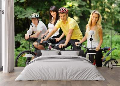 Group of people on a bicycles in a countryside - portrait Wall mural