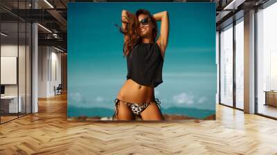 Summer fashion portrait of beautiful woman having fun on a summer beach Wall mural