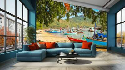 Colorful fishing boats on the beach in Thailand Wall mural