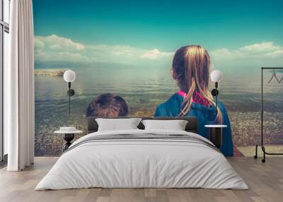 Little children standing on the lake shore Wall mural