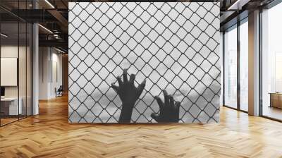 Hands holding fence on outdoor Wall mural