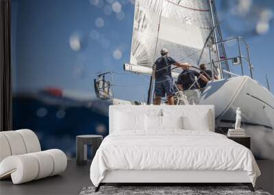 Aft of sailing boat with skipper from underwater view Wall mural