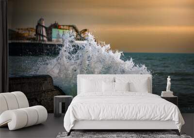 Big wave breaking into a pier stone wall on a windy evening in Brighton, East Sussex, UK. Wall mural