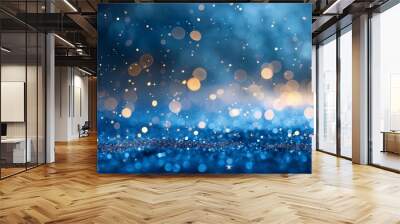 Blue and gold abstract glittery background with sides, Sparkling gold dust particles fly in the air on dark blue background. Abstract light effect. Christmas or birthday concept Wall mural