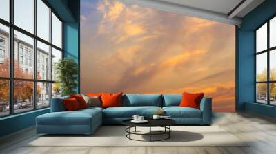 bright white and orange clouds in the blue sunset sky Wall mural