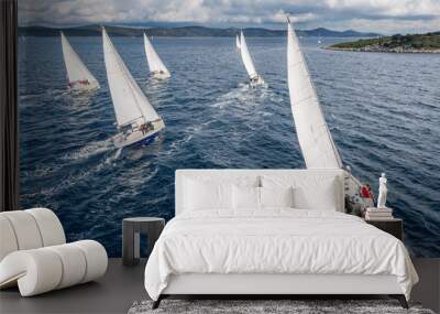 Fleet of sailing boats during offshore race from bird view Wall mural