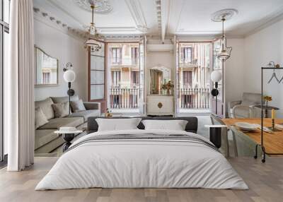 Front view to the retro style living room, with dining table, sofa, tile floor, vintage chandeliers and balconies. Beautiful bright interior. Wall mural