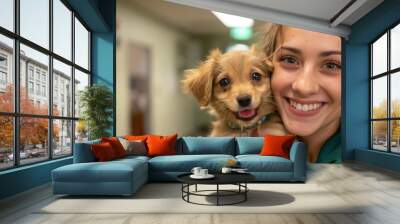 A shelter worker smiles happily while holding a cute puppy Wall mural